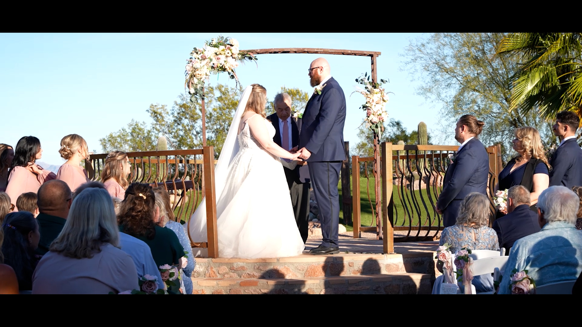 A couple exchanging vows at an outdoor Arizona wedding ceremony